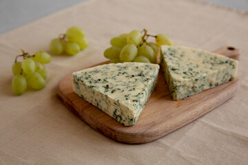 Delicious Cheese Danablu on a wooden board, side view.