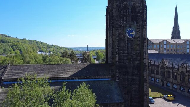 aerial climbing view of Halifax Minster a medieval church building in west yorkshire surrounded by town buildings