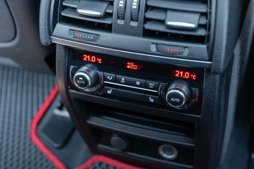 Heated seats and ventilation control panel in a car. Climate conditioning controls for rear seat passengers.
