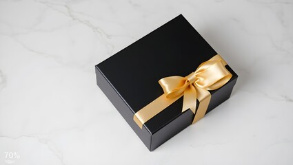 Luxury black gift box with golden ribbon on marble background for greeting cards and banners