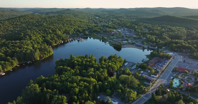 web, new york, usa - july 22, 2025: afternoon aerial summer video of the hamlet of old forge and old forge pond.  Pedestal movement down.