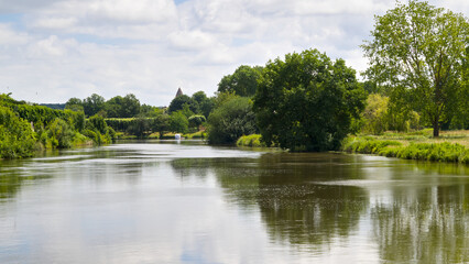 Scenic view of the Charente River in Saintes with adjacent park areas and greenery