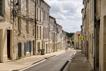 Narrow empty street in Saintes, showing historic buildings and quiet urban atmosphere