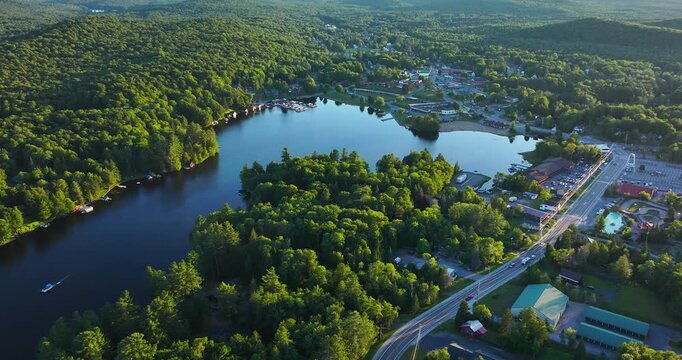 web, new york, usa - july 22, 2025: afternoon aerial summer video of the hamlet of old forge and old forge pond.  panning movement from right to left.