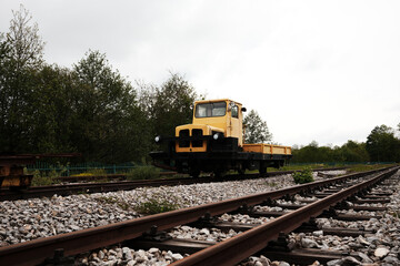 Small yellow industrial railway vehicle on tracks at Mokra Gora station in Serbia