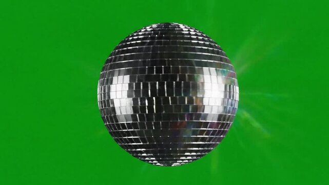 A classic rotating mirrorball reflecting shimmering light beams for a festive nightclub atmosphere or a vintage seventies disco dance party celebration and entertainment event