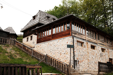 Traditional stone and wood house with panoramic windows in Drvengrad village, Mokra Gora, Serbia