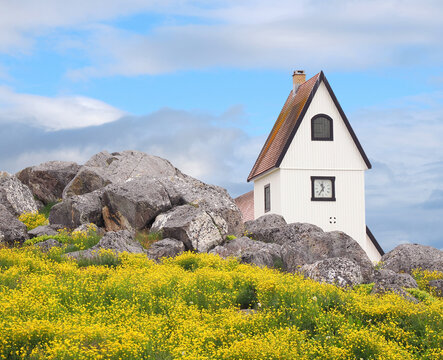 The Nanortalik, Greenland Church Hiding Behind the Iconic Boulders and Flowers of the Area