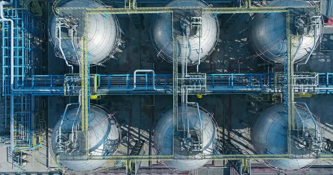 Aerial shot of spherical gas storage tanks at an industrial petrochemical facility.