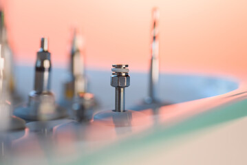 Full set of dental implant drill bits in surgical tray, close-up of professional dentistry equipment