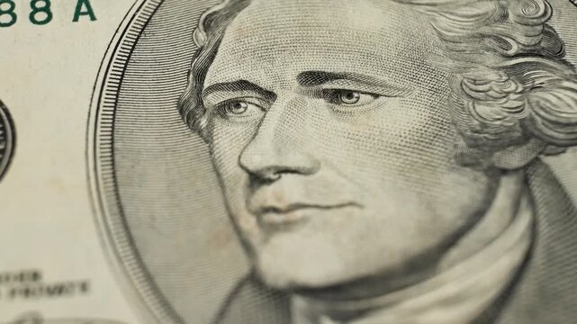 Artistic representation of male portrait Alexander Hamilton on banknote. Visible security features. Paper fibers on USA money. Budgeting expenses with physical currency on hand