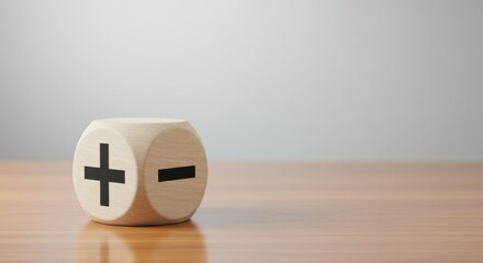 A wooden block on a table with plus and minus signs, symbolizing the process of weighing pros and cons before making a decision
