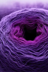 Close up of a vibrant purple and pink gradient yarn ball texture.