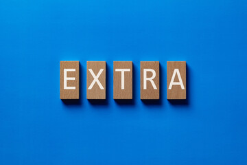 There is wood block with the word EXTRA. It is as an eye-catching image.