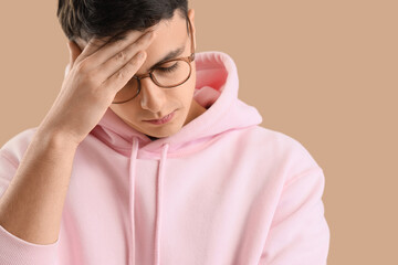 Worried young man on beige background