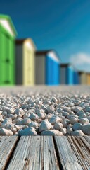 Colorful Beach Huts and Pebbles on a Sunny Day.