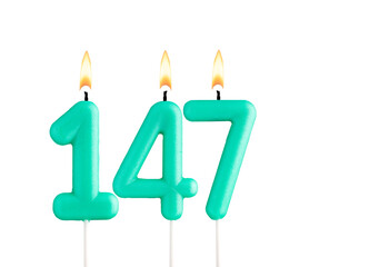 Green candles forming the number 147 - White background