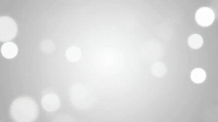 Monochromatic gray and white bokeh lights softly rippling and fading in a minimalist, seamlessly looping video gentle movement, defocused, softly rippling - Powered by Adobe