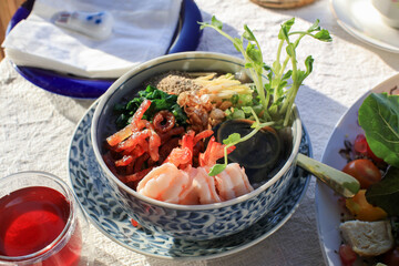 Rice porridge with shrimp, Century Egg and vegetable. Breakfast table under morning sunlight. Asian food 