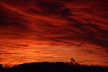 arafed sky with a red sky and a few clouds