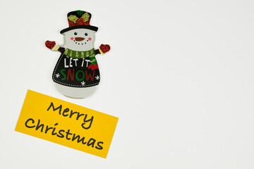 Cute Christmas ornament dressed appropriately for the December holiday with a holiday greeting sign, with a white background and copy space