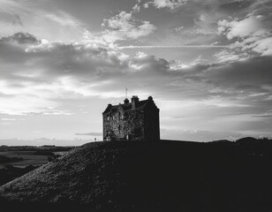Obraz premium Castle perched on hilltop with dramatic clouds