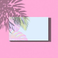 Light blue card on pink surface, overlain with pastel, colorful tropical leaves' illustration and soft shadow of palm fronds on upper left
