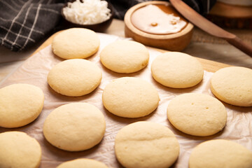 Alfajores cookies. A traditional dessert popular in Latin America, it consists of two cookies sandwiched together with dulce de leche, topped with powdered sugar or shredded coconut.