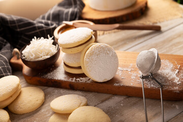 Alfajores. A traditional cookie popular in Latin American, it consists of two cookies joined together with dulce de leche forming a sandwich, covered with powdered sugar, grated coconut or chocolate.