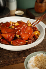 Gourmet braised pork knuckle with spicy marinated sauce and rice - traditional Asian cuisine