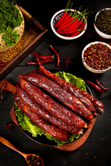 Traditional Sichuan Spicy Pork Sausages with Chili Peppers and Chinese Spices on Wooden Board