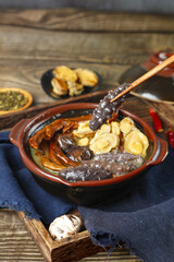 Chinese Black Sesame Sweet Soup Dessert with Walnuts in Clay Bowl