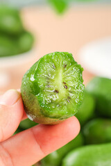 Fresh Kiwi Berry with Heart Pattern Held in Hand - Healthy Green Fruit Close-up