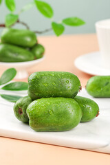 Fresh Mini Kiwi Fruits with Water Drops on Cutting Board - Healthy Organic Food Photography
