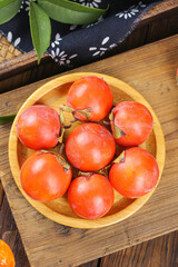 Fresh Persimmons in Wooden Bowl - Sweet Asian Fruit Display on Rustic Wood Table