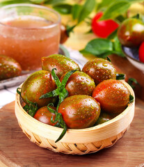 Fresh Wet Tomatoes in Wooden Basket Still Life on Rustic Kitchen Table