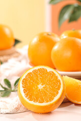 Fresh Orange Half with Juicy Citrus Segments and Whole Oranges on Wooden Background
