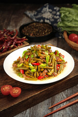 Chinese Stir-Fried Green Beans with Minced Pork and Pickled Vegetables on Wooden Table