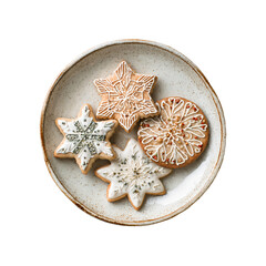 Four decorated snowflake and circular cookies on a speckled ceramic plate, top-down view.
