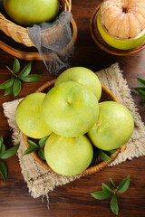 Freshly Picked Yuhuan Pomelo and Citrus Fruits in Rustic Baskets on Wooden Background