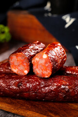 Homemade Spicy Szechuan Smoked Pork Sausages Sliced on Wooden Cutting Board