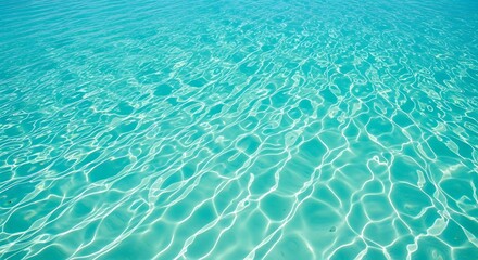 Obraz premium Calm and transparent turquoise sea water with beautiful sunlit caustics on the sandy seabed