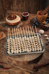 Traditional Shaanxi Chinese Kebab Skewers with Spices on Rustic Wooden Table - Authentic Asian Street Food Specialty Closeup