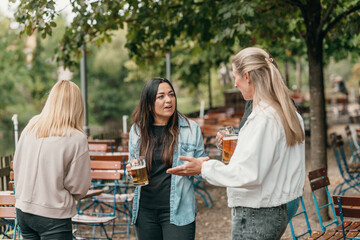 Friends celebrate summer in Bavaria with beer toasts at a traditional beer garden enjoying laughter friendship culture and festive joy together