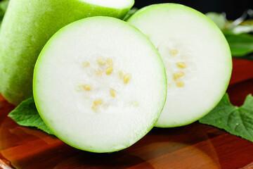 Freshly Sliced Shandong Winter Melon on Wooden Board - Organic Healthy Vegetable with Seeds and Leaves