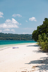 Small purple kayak on the beach
