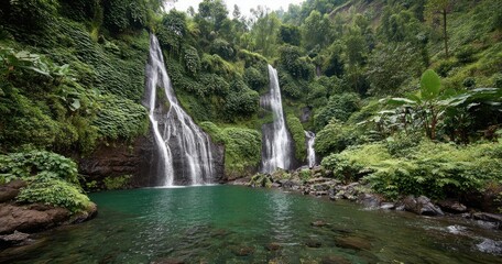 Lush jungle scene showcasing two cascading waterfalls plunging into a serene emerald pool, surrounded by vibrant green foliage and rocks