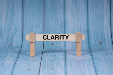 Clarity symbol. Wooden stick clamped by Clothespins, vivid blue wooden backdrop. Business and Clarity concept with copy space