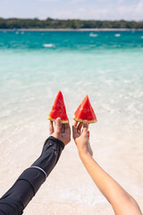 woman holding watermelon on the beach