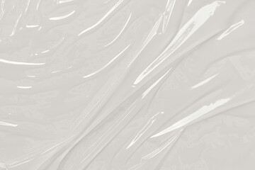 Crumpled clear plastic sheet with bright lighting, suitable for graphic design projects, website backgrounds, and presentations.